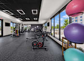 Thumbnail 25 of 26 - A gym with a row of exercise bikes and a purple exercise ball.