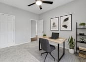 Thumbnail 1 of 45 - A room with a desk, chair, and a ceiling fan.