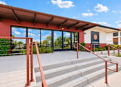 Thumbnail 15 of 26 - A building with a red awning and a sign that says "EMER" is shown.