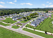 Thumbnail 16 of 33 - A suburban neighborhood with houses and a road.