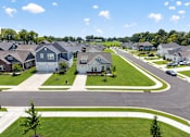 Thumbnail 15 of 33 - A suburban neighborhood with houses and a clear sky.