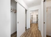 Thumbnail 14 of 66 - a hallway with white walls and a closet with mirrored doors