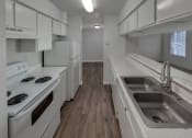 Thumbnail 8 of 19 - a kitchen with white appliances and white cabinets