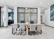 Thumbnail 22 of 28 - A modern dining room with a large table and chairs.