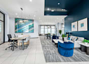 Thumbnail 14 of 28 - A modern office space with a blue accent wall and a variety of seating options.