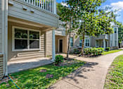 Thumbnail 39 of 42 - a sidewalk in front of an apartment building with trees