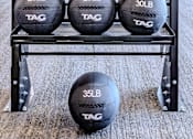 Thumbnail 16 of 41 - A set of TAG weighted balls arranged on a rack by weight.