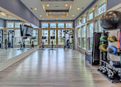 Thumbnail 17 of 41 - A spacious gym with a variety of exercise equipment.