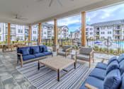 Thumbnail 5 of 41 - A patio with blue couches and a striped rug.