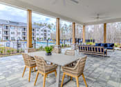 Thumbnail 11 of 41 - A patio with a table and chairs is shown.