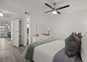 Thumbnail 9 of 23 - A bedroom with a bed, dresser, and mirror.