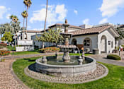 Thumbnail 23 of 23 - A fountain in front of a building with a sign that says "The Clifford".