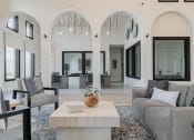 Thumbnail 37 of 43 - a living room with white walls and a large white coffee table in the middle of the room