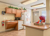 Thumbnail 20 of 23 - A kitchen with a red kettle on the counter.