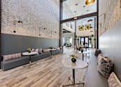 Thumbnail 27 of 33 - A modern interior with a brick wall and wooden floors.
