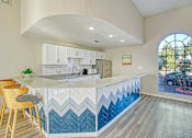 Thumbnail 17 of 28 - a kitchen with white cabinets and blue chevron tile