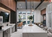 Thumbnail 17 of 47 - A modern kitchen with a marble countertop and a large island.