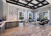 Thumbnail 29 of 33 - A modern kitchen with a bar area and a dining table.