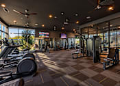 Thumbnail 27 of 30 - A gym with treadmills, weights, and exercise equipment.