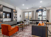 Thumbnail 4 of 11 - A living room with a red chair and a black couch.