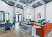 Thumbnail 4 of 39 - A modern living room with a white sofa and blue chairs.