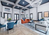 Thumbnail 6 of 39 - A modern living room with a white sofa and blue chairs.