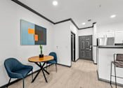Thumbnail 14 of 29 - A modern dining area with a round table and chairs.