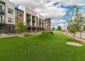 Thumbnail 32 of 36 - the preserve at ballantyne commons grass courtyard with apartment buildings