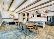 Thumbnail 22 of 33 - A modern kitchen with a dining table and chairs.
