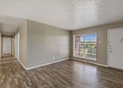 Thumbnail 8 of 16 - A room with wooden floors and white walls.