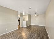 Thumbnail 7 of 16 - A room with wooden flooring and a ceiling fan.