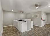 Thumbnail 15 of 16 - A laundry room with a washer and dryer.