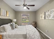 Thumbnail 5 of 16 - A bedroom with a large bed and a ceiling fan.