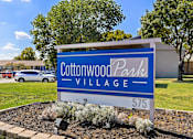 Thumbnail 16 of 16 - A sign for Cottonwood Park Village with the number 575 on it.