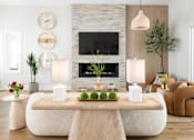 Thumbnail 14 of 19 - A modern living room with a stone fireplace and a large clock on the wall.