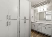 Thumbnail 13 of 20 - a bathroom with white cabinets and a sink and a mirror