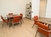 Thumbnail 20 of 28 - A room with a table and chairs and a bookshelf.