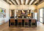 Thumbnail 11 of 23 - a kitchen with a large center island with a wooden countertop