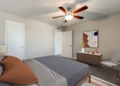 Thumbnail 8 of 20 - a bedroom with a large bed and a ceiling fan