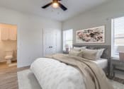 Thumbnail 31 of 65 - a bedroom with a bed and a ceiling fan
