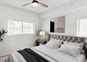 Thumbnail 31 of 33 - a bedroom with a large bed and a ceiling fan