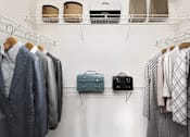 Thumbnail 22 of 33 - a closet filled with suitcases and clothes on a rack