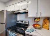 Thumbnail 1 of 19 - a kitchen with stainless steel appliances and white cabinets
