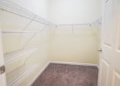 Thumbnail 8 of 16 - Empty white shelves in a room.