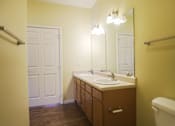 Thumbnail 9 of 16 - A bathroom with a sink, mirror, and a white door.