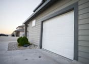 Thumbnail 11 of 16 - A white garage door is closed.