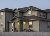 Thumbnail 15 of 16 - A house with a garage and a motorcycle parked outside.