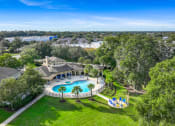 Thumbnail 4 of 67 - an aerial view of a swimming pool and a mansion with trees and a pool party