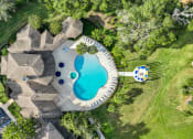 Thumbnail 1 of 67 - a backyard pool with a pool house and a swimming pool