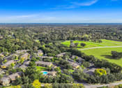 Thumbnail 2 of 67 - an aerial view of a neighborhood with houses and trees and a golf course